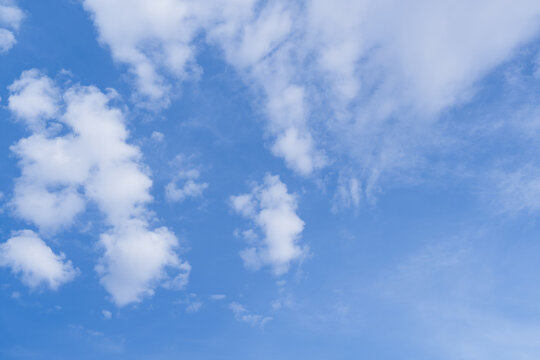 Blue Sky Background With White Fluffy Clouds In Bright Spring And Summer Daylight, Autumn Winter Natural Cloudscape And Clear Weather Scene For Seasonal Banner,Travel Design, Wallpaper Presentation