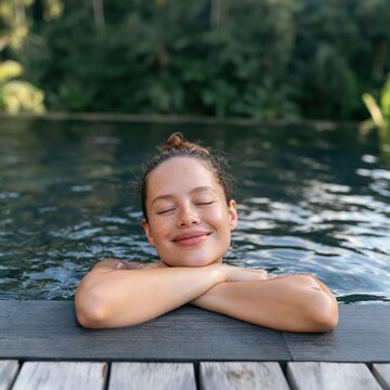 Relaxed woman resting at pool edge with closed eyes for wellness background and spa lifestyle imagery