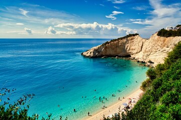 Obraz premium Swimmers in crystal clear turquoise water at Porto Katsiki beach in Lefkada island Greece