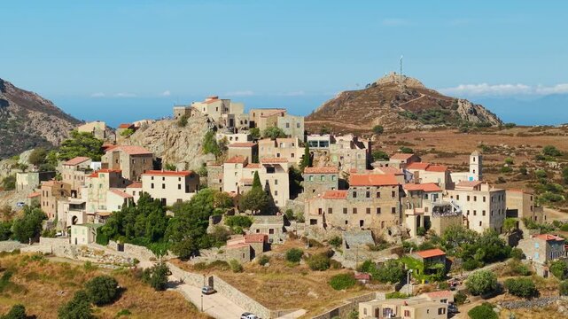 Sant Antonino Corsica France aerial 70mm telephoto drone hilltop authentic village mountains landscape cinematic Balagne region travel destination 4k video
