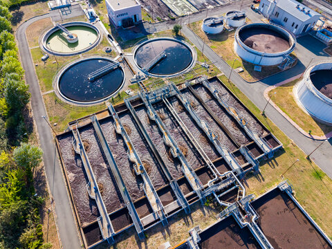 Wastewater treatment facility in operation during the daytime showing various tanks and equipment clearly