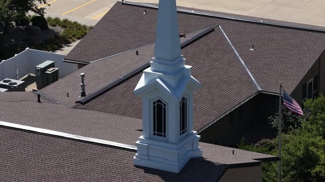 Aerial close up of church steeple and roof in Junction City Kansas