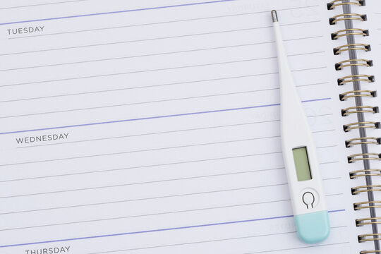 Blank daily planner with a thermometer for scheduling healthcare appointments