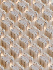 Fototapeta premium Large number of small square-shaped objects arranged in a grid-like pattern on a beige background.