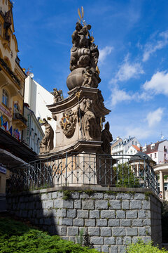 Karlovy Vary has a monument that displays historical figures and symbols on a hill in Czech Republic