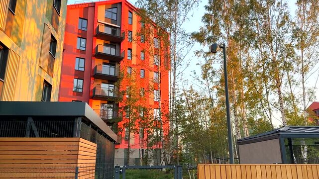 Modern Modern condominium building with courtyard block. New residential multifamily home, building in eco neighborhood. Sustainable and affordable housing in green communities. Multi-apartment condo 