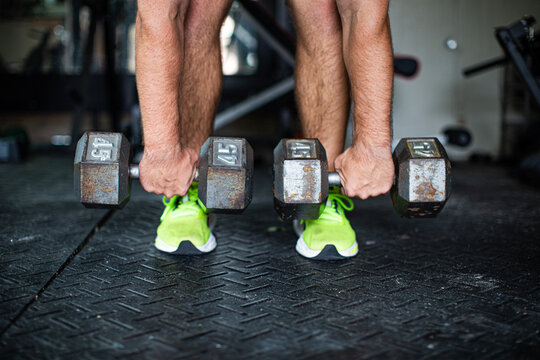 man holding dumbbells 