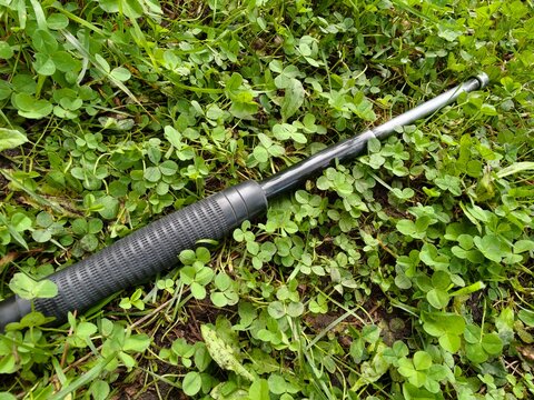telescopic baton in his hand on the street. self defense weapon