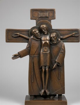Friars gathered at cross bronze relief