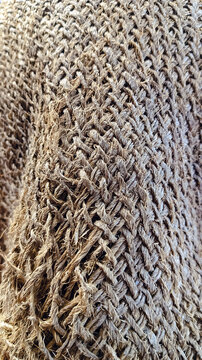 Burlap fabric texture background, natural jute textile with coarse weave and frayed edges, rustic brown eco material surface for design and packaging