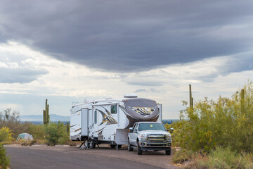 Rv trailer and pickup at desert campsite © KRoberts