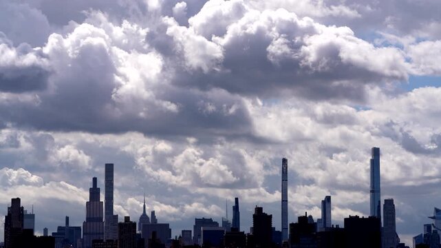 Stunning stock video of dramatic moving clouds rolling over a sprawling modern city skyline, perfect for weather, urban, and travel projects.

