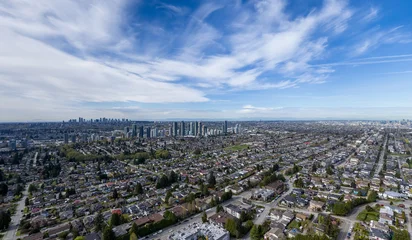 Aerial View of Vancouver City Skyline and Suburban Neighborhoods Under Blue Sky and Wispy Clouds © edb3_16