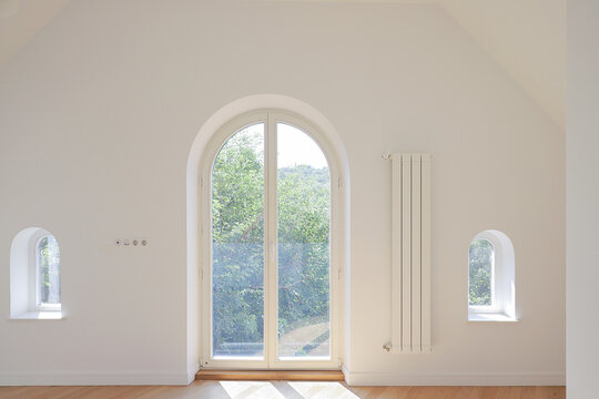 Empty apartment room arched window