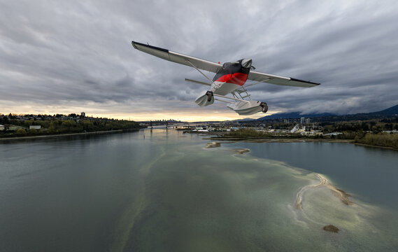Red Floatplane Flying Over River Estuary With City Skyline and Dramatic Cloudy Sky, BC Background