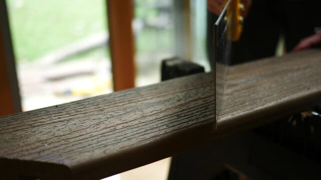 Man uses Saw on Composite Deck Board