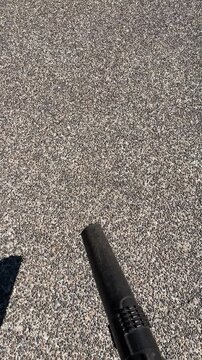 Leaf Blowing a Aggregate Driveway