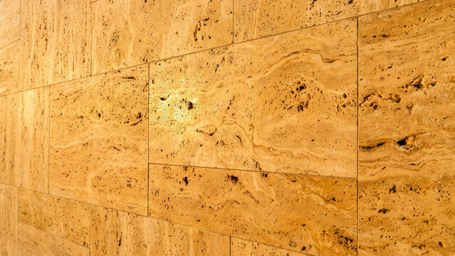 Polished tan travertine stone tile wall texture