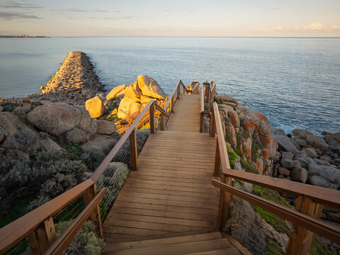 Sunset light on the Granite Island stone jetty in Victor Harbor South Australia from the elevated timber walkway