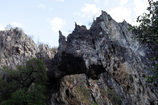 Majestic natural rock arch framed by wild trees in Chapada dos Veadeiros Goias Brazil