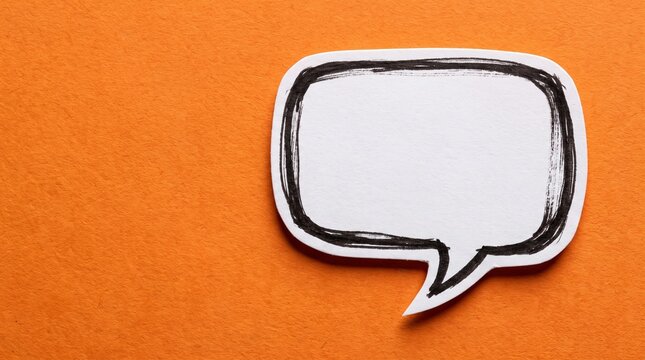 A white paper speech bubble rests on an orange background for communication concepts.