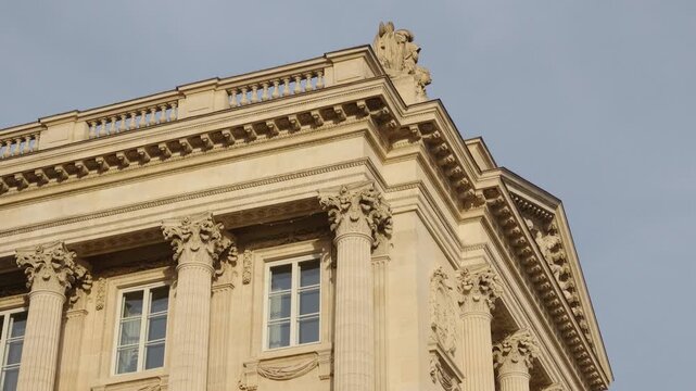 Ornate architectural details with columns and carvings adorning a historic building in Paris