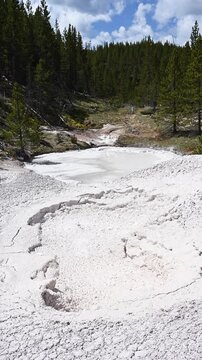 Boiling clay mud pot at Artists' Paintpots area of Yellowstone National Park, summer vacation destination for outdoor nature recreation.
