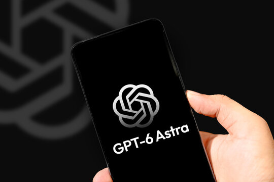 Hand holding smartphone displaying GPT-6 Astra logo in illustrative editorial technology concept background