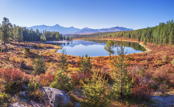 Mountain lake on an autumn morning, sunny weather, forest shores