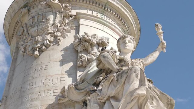 Close up of Marianne statue holding torch at Place de la Republique in Paris