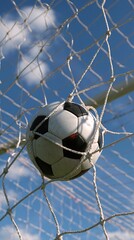 Naklejka premium Black and white soccer ball caught in goal