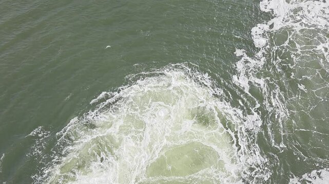 View from ferry upper deck of turbulent water and propeller wash while turning