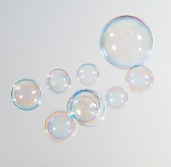 Obraz premium Colorful soap bubbles floating on white background
