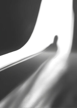 Abstract grayscale image depicting a curved, undefined form against a dark backdrop