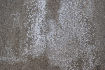 Grungy concrete wall texture with white efflorescence and dark shadows, creating a weathered and aged background surface © Vero Dibe