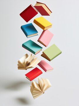 Colorful books floating in white space