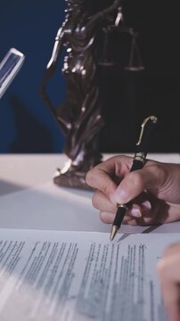 Close-up of judge gavel and scales of justice on lawyer desk.