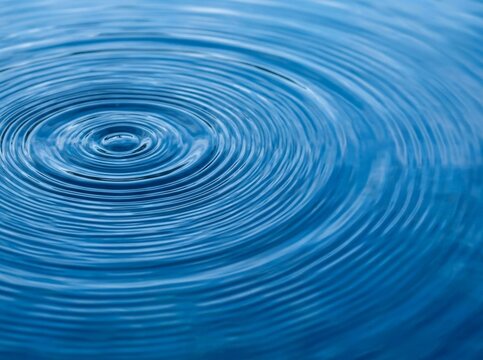 Close-up of rippling water surface with concentric circles