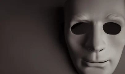 Anonymous white mask emerging from dark background symbolizes digital identity fraud, impersonation, scams, phishing, identity theft, online deception, security threats, and fraud prevention concept. © tete_escape