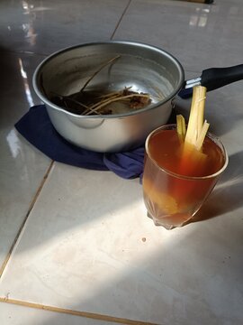 Herbal drink for body warming, contains ginger and serai pouring milk into a glass