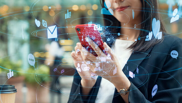 A woman using a smartphone in the city and social networks