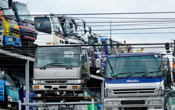 PATHUM THANI, THAILAND-JULY 3, 2022: Used truck cab inventory at commercial vehicle yard. Secondhand heavy transportation fleet for logistics, freight delivery, cargo distribution industrial business.