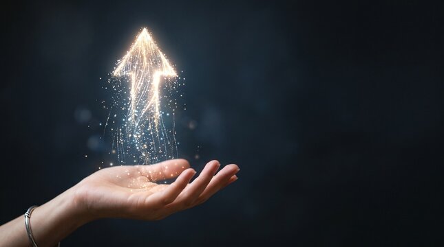 Hand releasing a magical glowing upward arrow made of sparkling particles representing business growth and success on dark background.