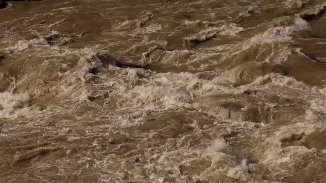 Close-up video captures the Himalayan Beas River surging with muddy water during the monsoon season in Mandi, Himachal Pradesh, India.