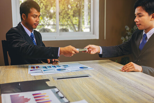 Employer paid marketing costs to employees for their work. Businessman pay cash salary for business partners. Selected focus.	