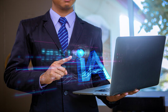 Businessman with computer laptop command order via devices with AI visual effect text. AI technology concept. Selected focus.