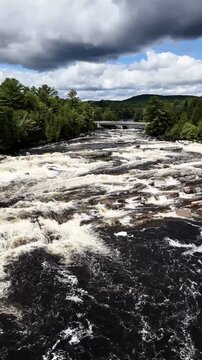 Drone flight above cascades and waterfalls park on the Ouareau River, in Rawdon, Quebec, Canada.