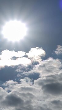 timelapse of bright sun shining dramatically behind thick dark cumulus cloud formations