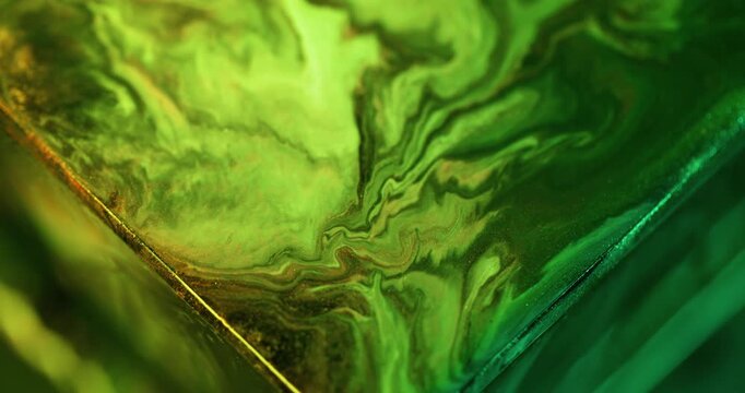 Ink splash. Neon pigment. Defocused green color triangle sparkling blend texture spilling on abstract acrylic creative background.