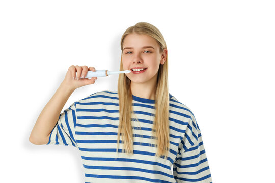 Woman actively brushes her teeth with electric toothbrush. Effective oral hygiene concept, PNG